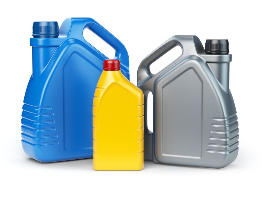 Different types of plastic canisters of motor oil on white isola